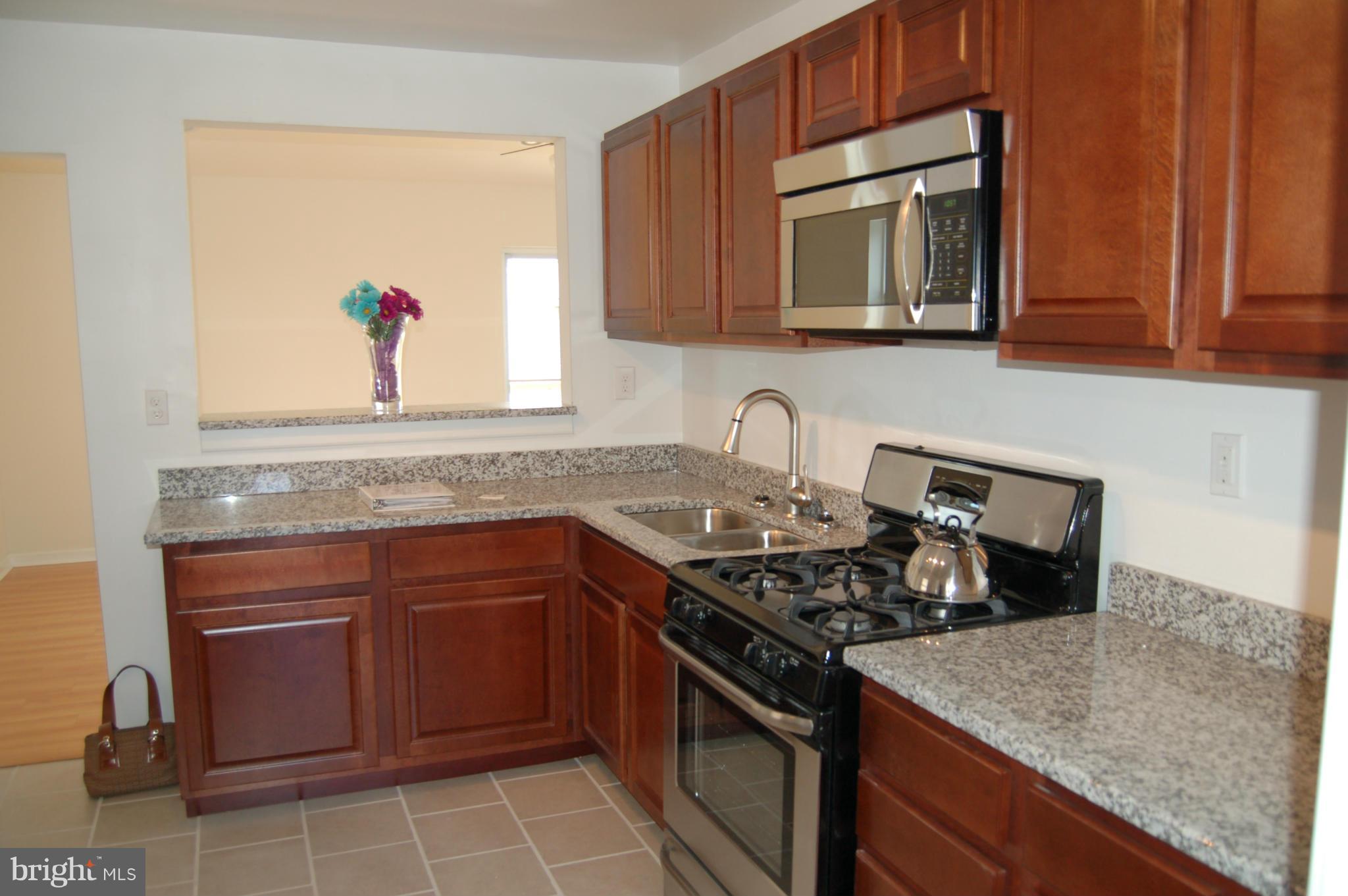 2 Plateau Road Baltimore, MD 21221 - Photo 8 of 28 a kitchen with a stove and a microwave