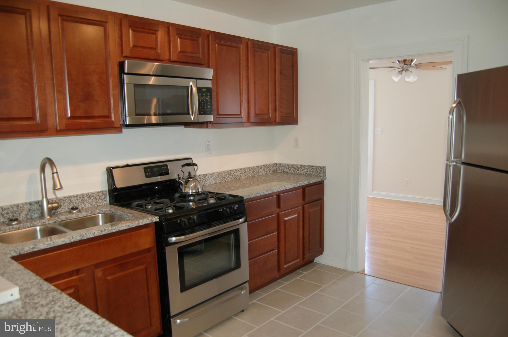 2 Plateau Road Baltimore, MD 21221 - Photo 9 of 28 a kitchen with stainless steel appliances granite countertop a stove microwave and refrigerator