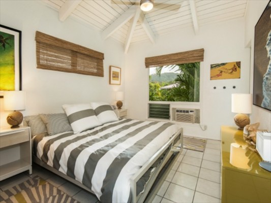 5325 Weke Road Hanalei, HI 96714 - Photo 7 of 25 a bedroom with a bed and wooden floor