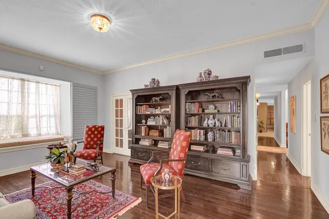 a living room with furniture a large window and a fireplace