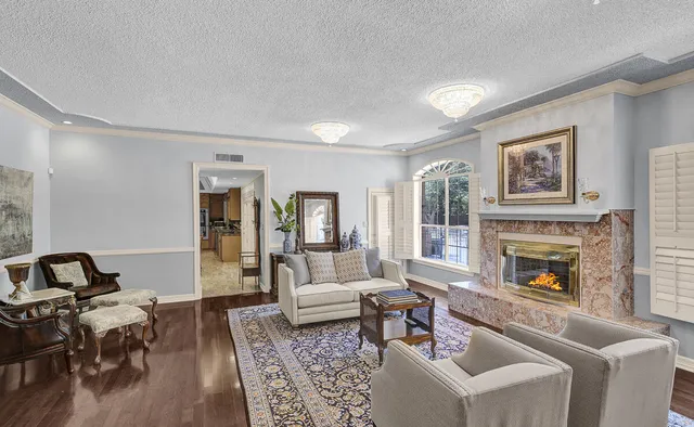 a kitchen with stainless steel appliances granite countertop a sink a stove and a wooden floors