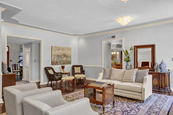 a view of a dining room with furniture and a chandelier