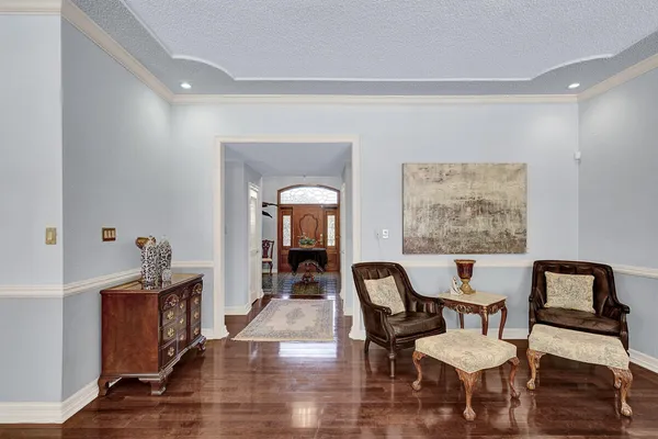a dining room with furniture potted plants and wooden floor