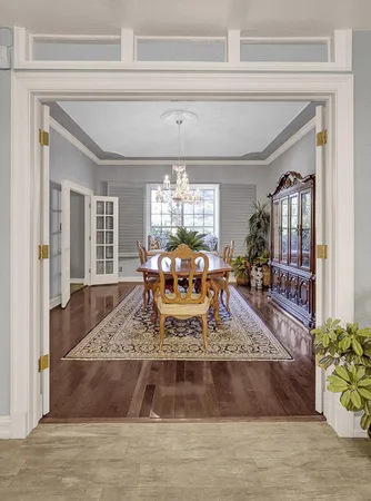 a bed sitting in a bedroom next to a window and a lamp