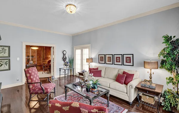 a living room with furniture fireplace and wooden floor