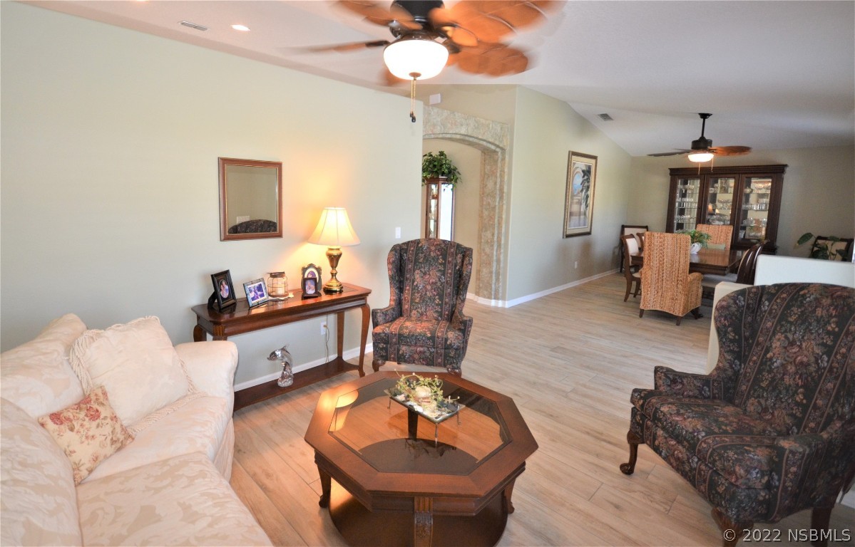 2924 Royal Palm Drive Edgewater, FL 32141 - Photo 20 of 43 a living room with furniture and a chandelier