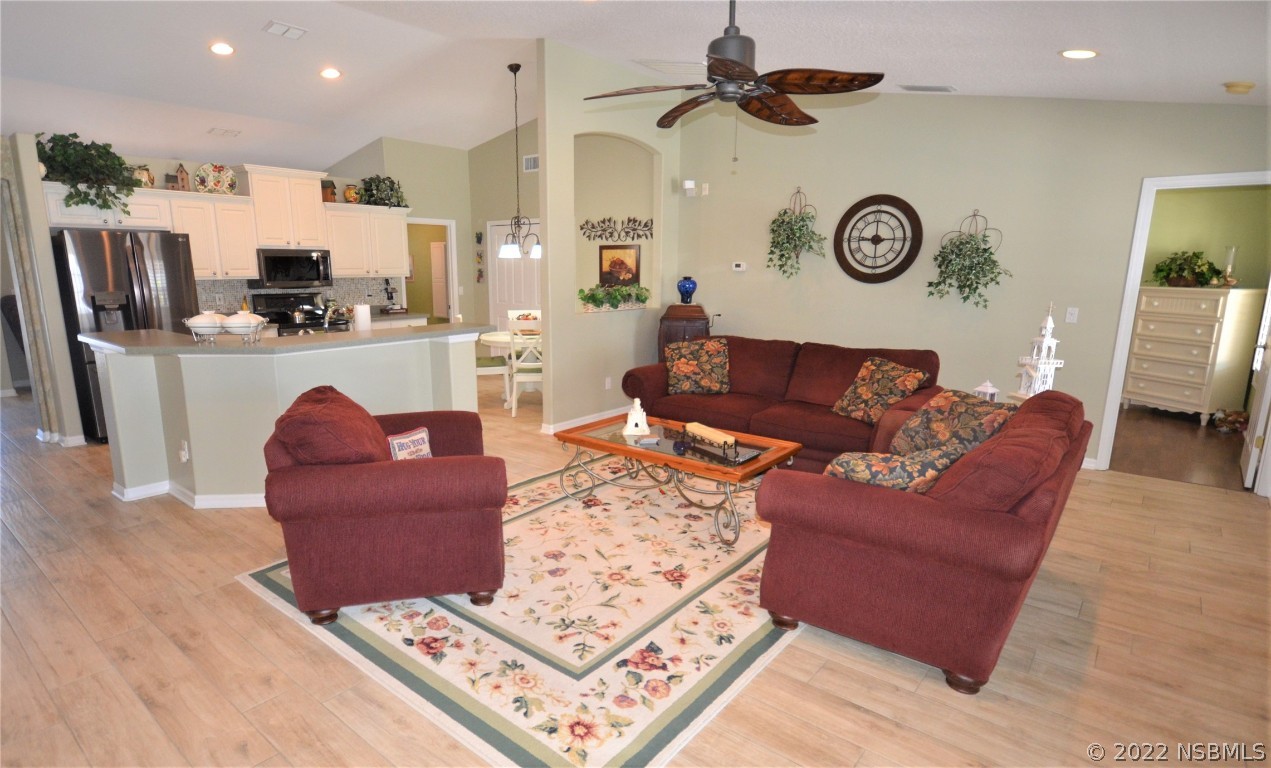 2924 Royal Palm Drive Edgewater, FL 32141 - Photo 23 of 43 a living room with furniture a clock and a view of kitchen