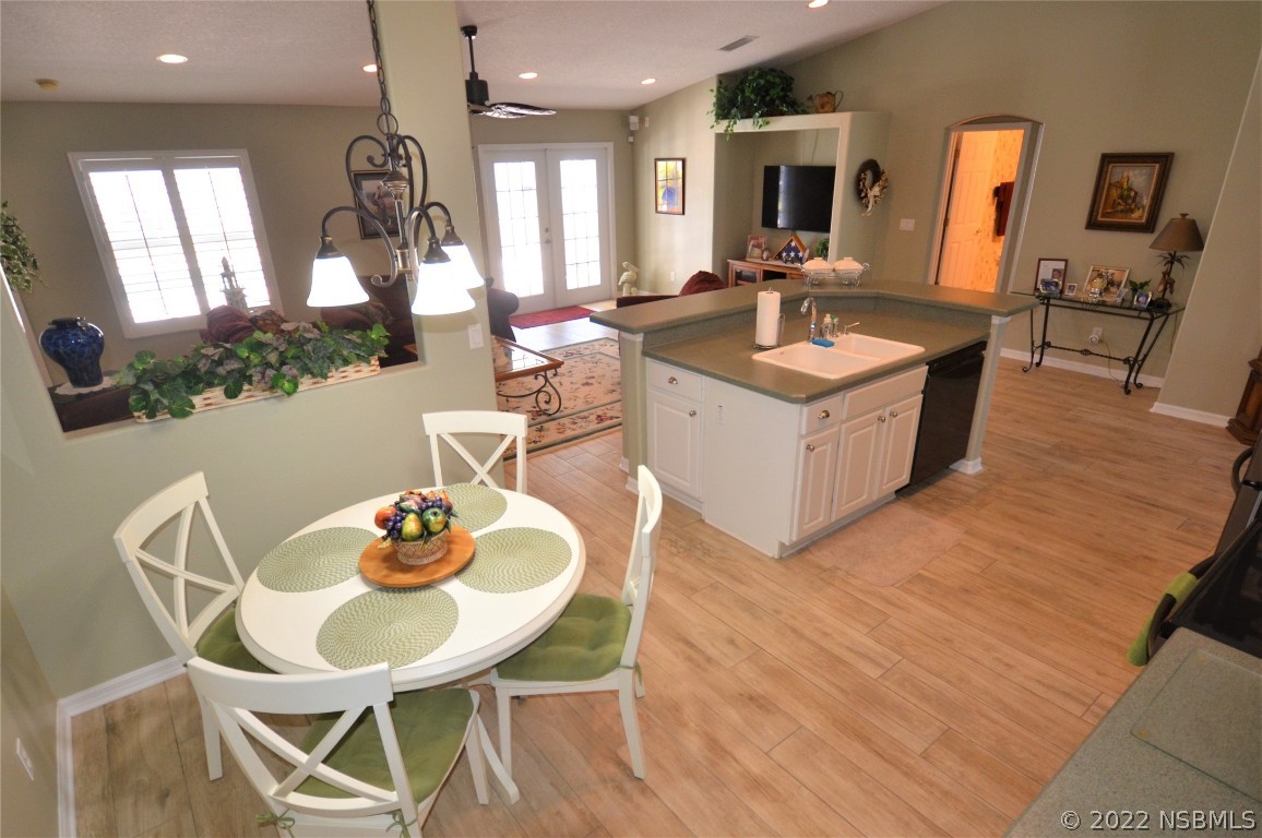 2924 Royal Palm Drive Edgewater, FL 32141 - Photo 27 of 43 a kitchen with a dining table chairs and living room