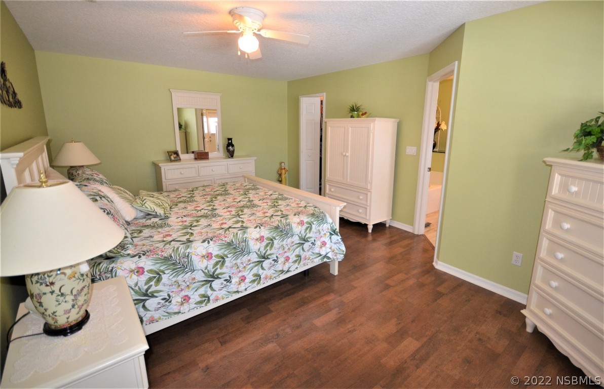 2924 Royal Palm Drive Edgewater, FL 32141 - Photo 32 of 43 a bedroom with a bed and a mirror on dresser