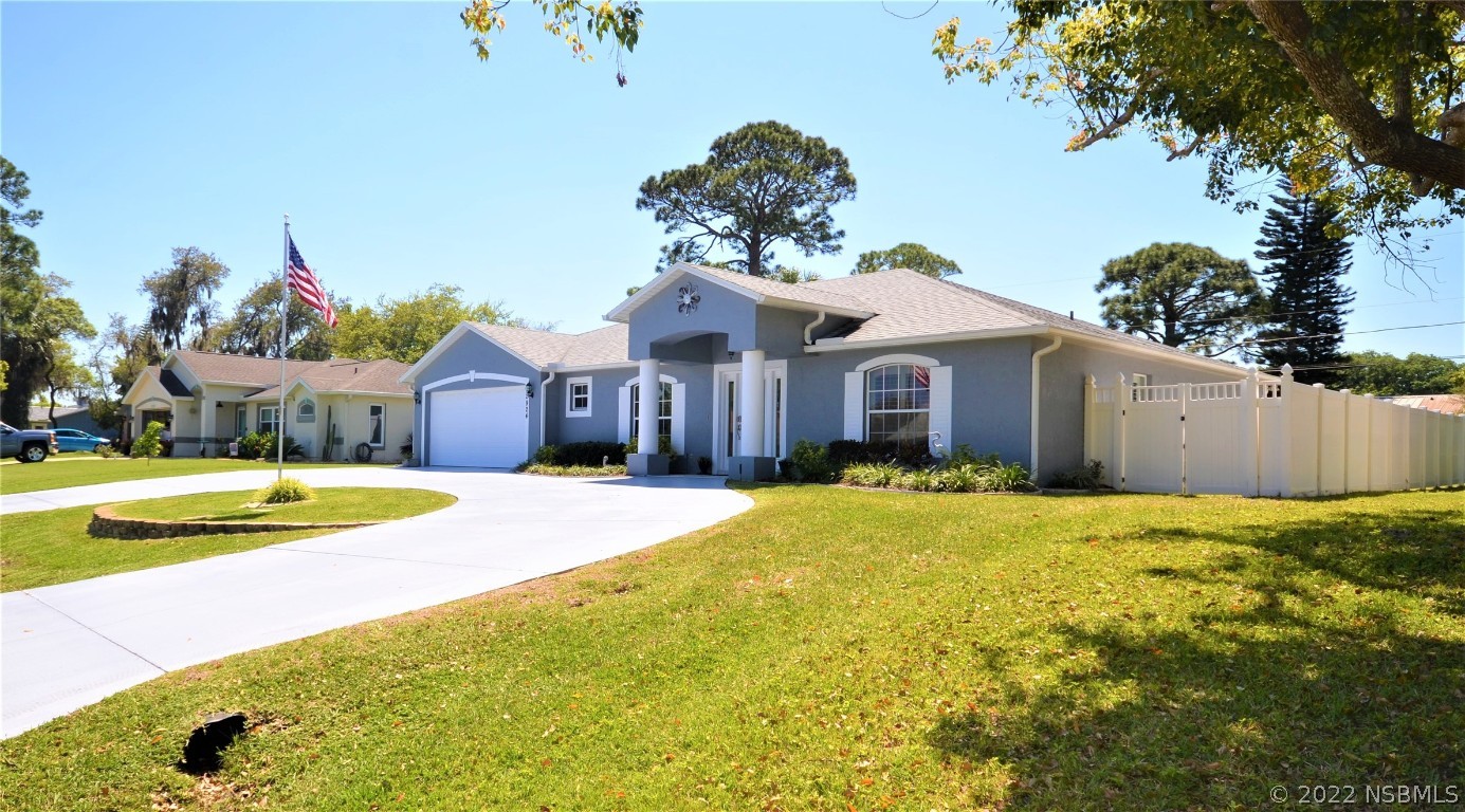 2924 Royal Palm Drive Edgewater, FL 32141 - Photo 6 of 43 a front view of a house with a yard and dinning table