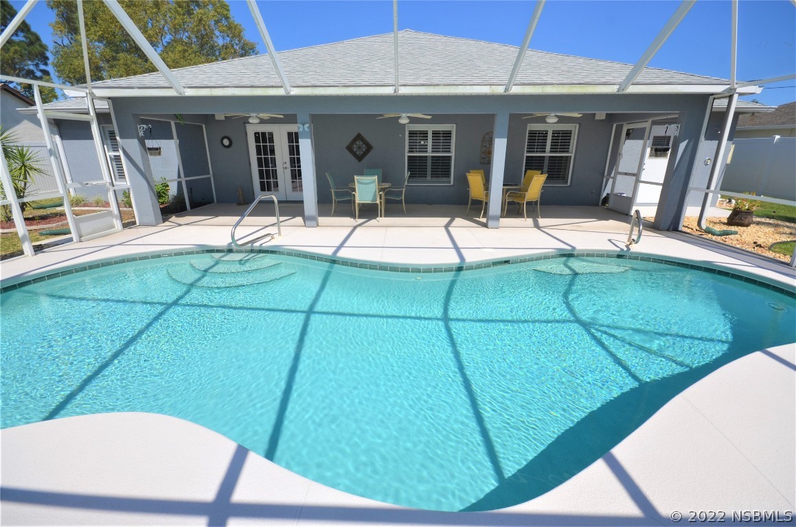 2924 Royal Palm Drive Edgewater, FL 32141 - Photo 7 of 43 a view of a house with floor to ceiling windows and a table