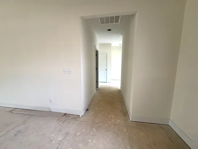 a bathroom with a granite countertop sink a toilet a mirror and shower