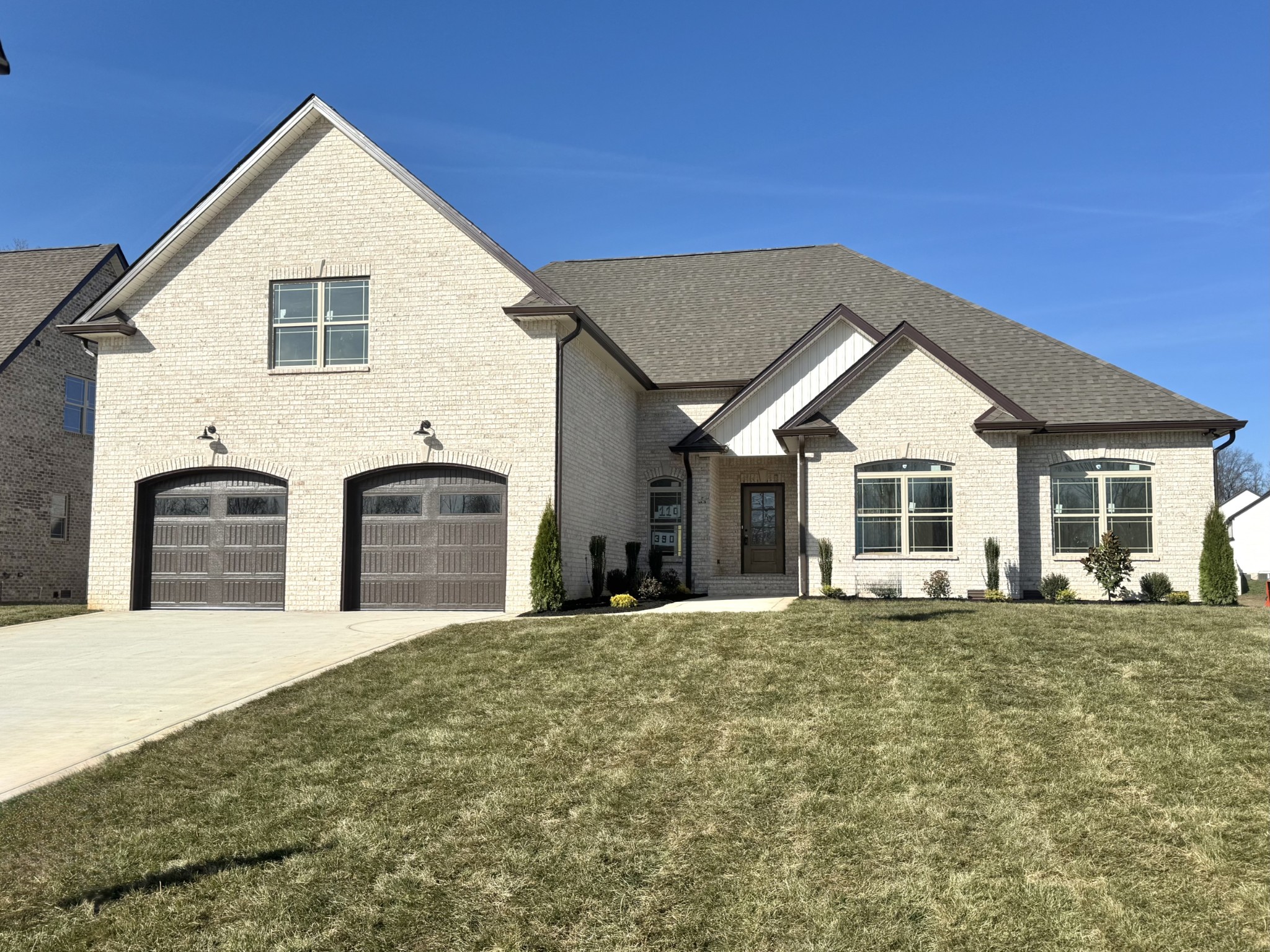 390 Young Lane Pleasant View, TN 37146 - Photo 2 of 48 a front view of a house with yard and trees in the background