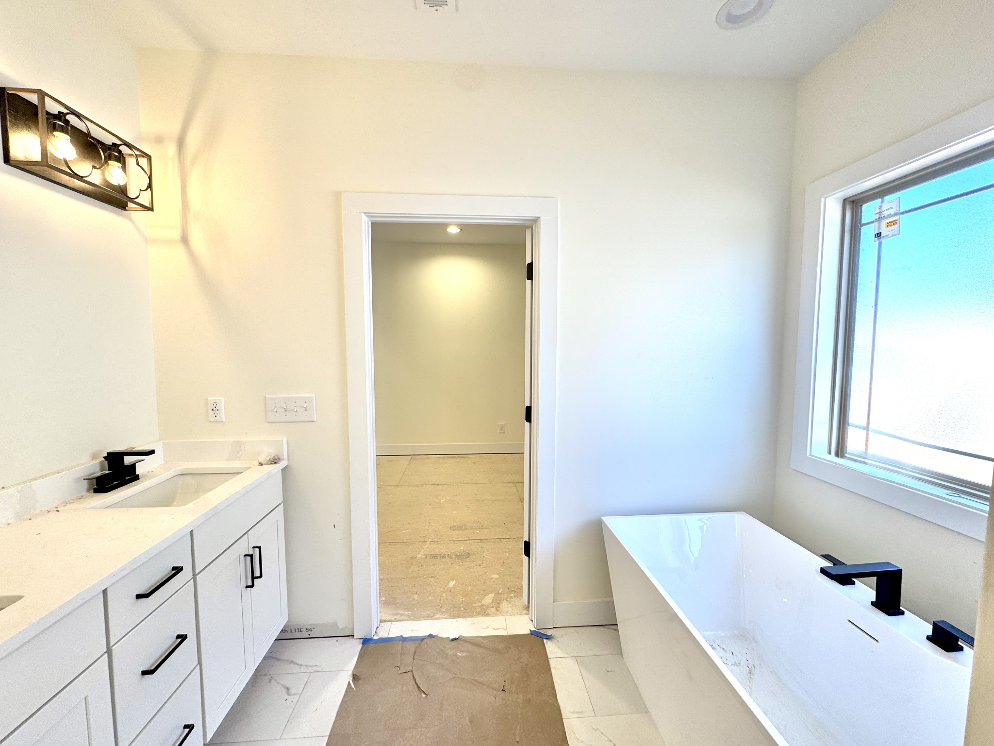 390 Young Lane Pleasant View, TN 37146 - Photo 25 of 48 a bathroom with a double vanity sink a mirror and a bathtub