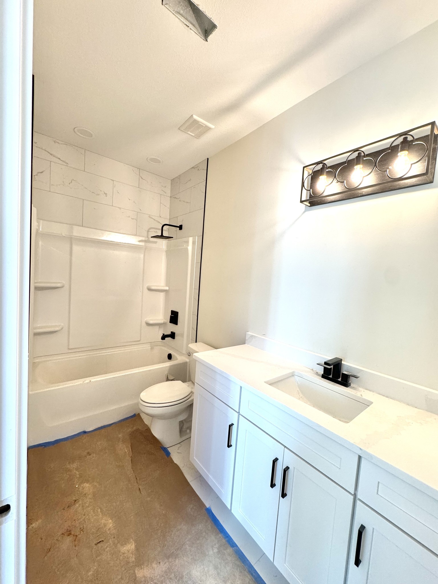 390 Young Lane Pleasant View, TN 37146 - Photo 36 of 48 a bathroom with a granite countertop sink a toilet a mirror and shower