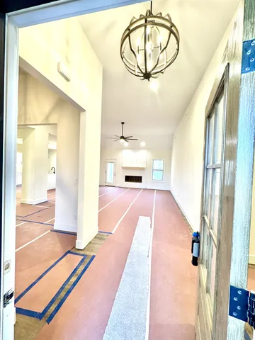 a kitchen with stainless steel appliances granite countertop a sink refrigerator and a wooden floor