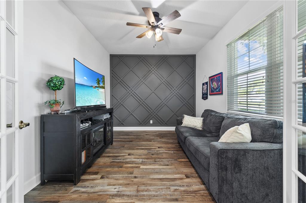 16948 Deer Island Road Tavares, FL 32778 - Photo 4 of 67 a living room with furniture and a flat screen tv