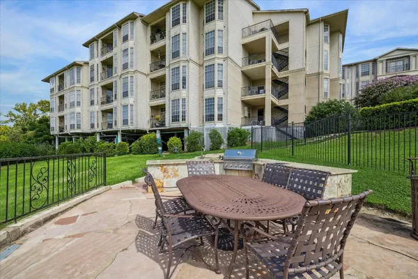 a view of a patio with a table and chairs