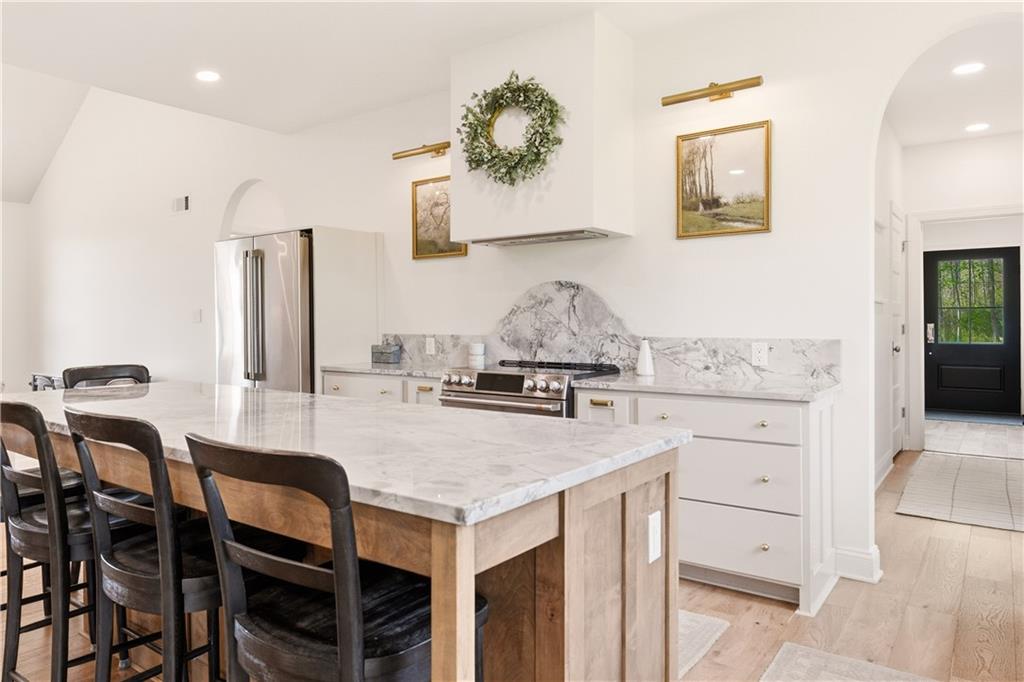315 Stewarton Road Mill Run, PA 15464 - Photo 18 of 47 a kitchen with a table chairs stove and kitchen island