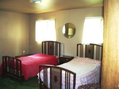 112 Duncan Ranch Road Hayfork, CA 96041 - Photo 8 of 20 a bedroom with a bed a dresser and a large mirror