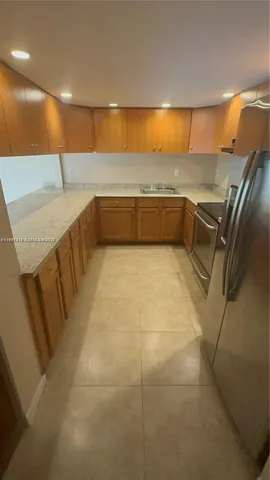 a kitchen with stainless steel appliances a sink and cabinets
