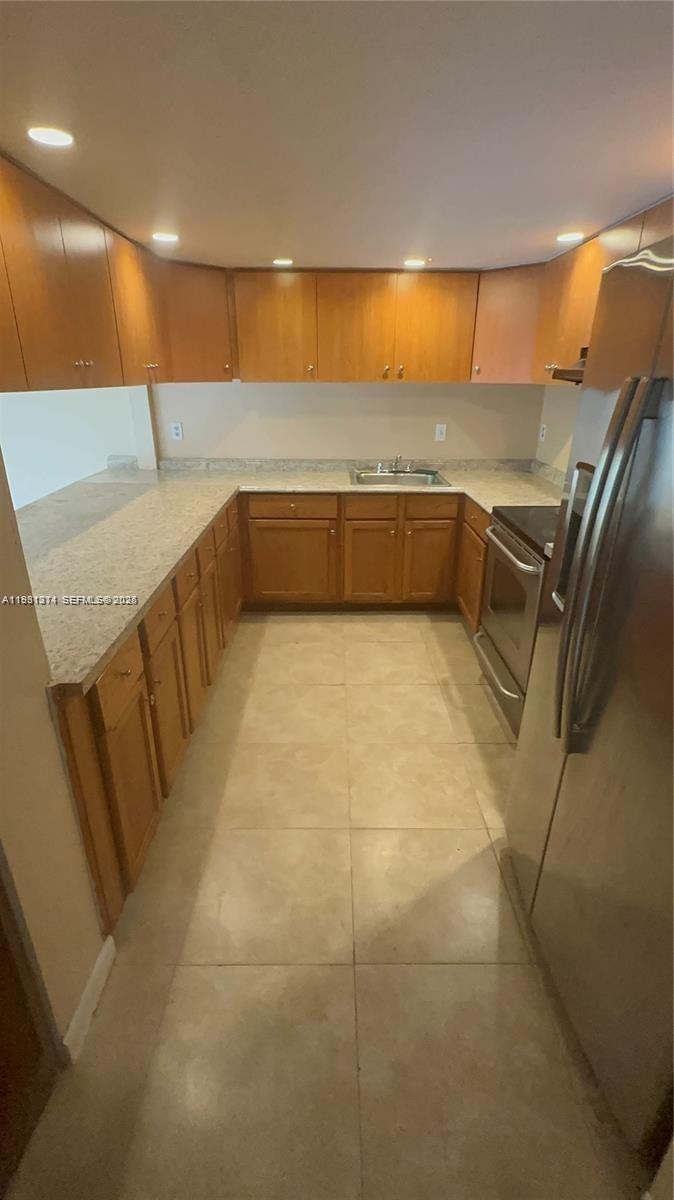 948 Southwest 74th Avenue North Lauderdale, FL 33068 - Photo 2 of 10 a kitchen with stainless steel appliances a sink and cabinets