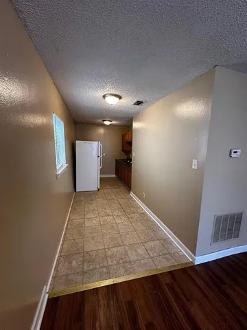 a kitchen with a refrigerator a stove and a sink