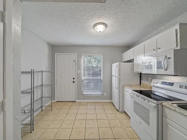 a kitchen with stainless steel appliances a refrigerator sink and cabinets