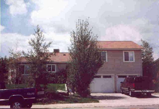 1553 Arabian Avenue Rifle, CO 81650 - Photo 1 of 4 a front view of a house with garden