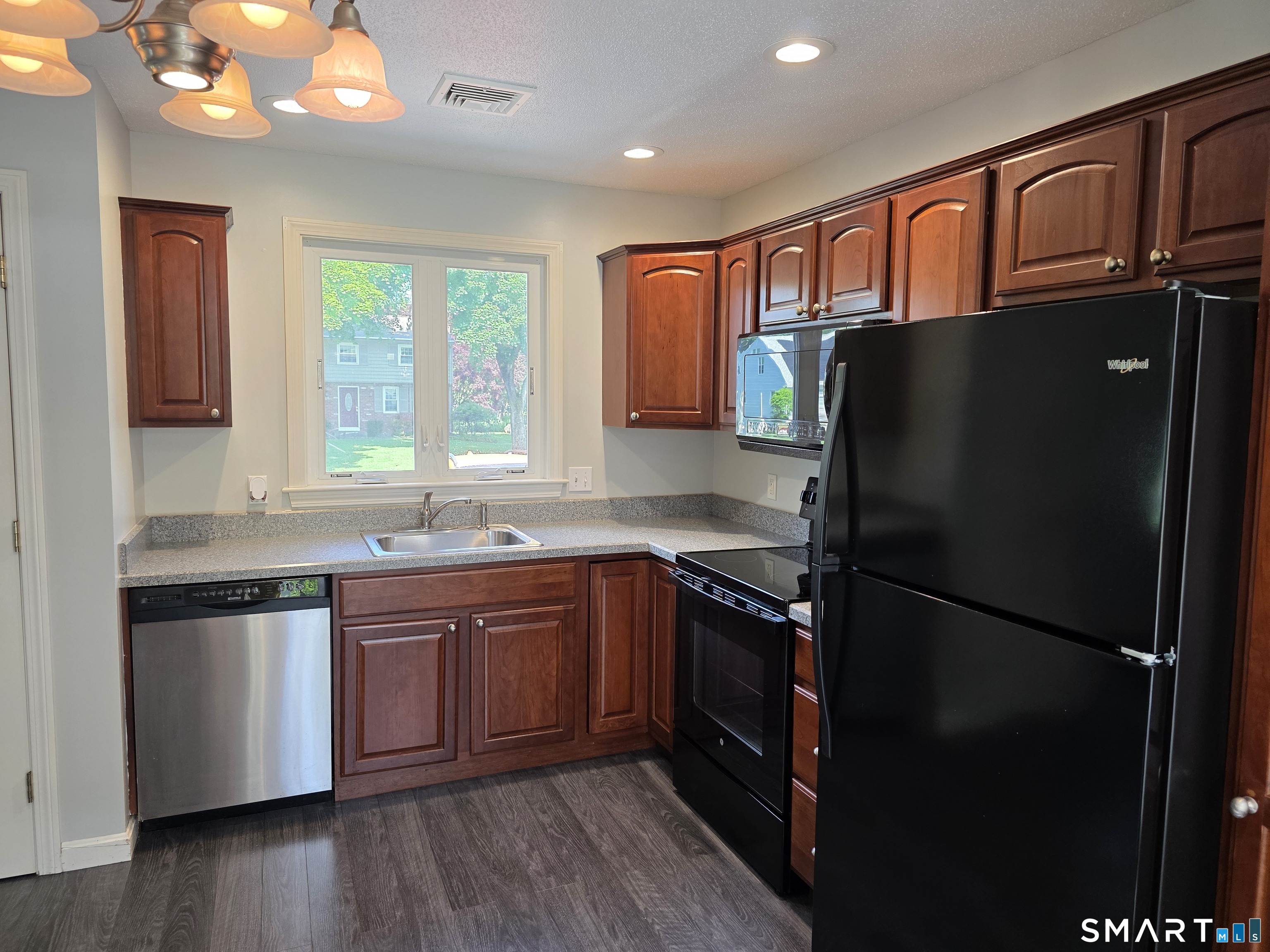 15 Van Buren Road Enfield, CT 06082 - Photo 32 of 40 a kitchen with stainless steel appliances granite countertop a refrigerator and a sink