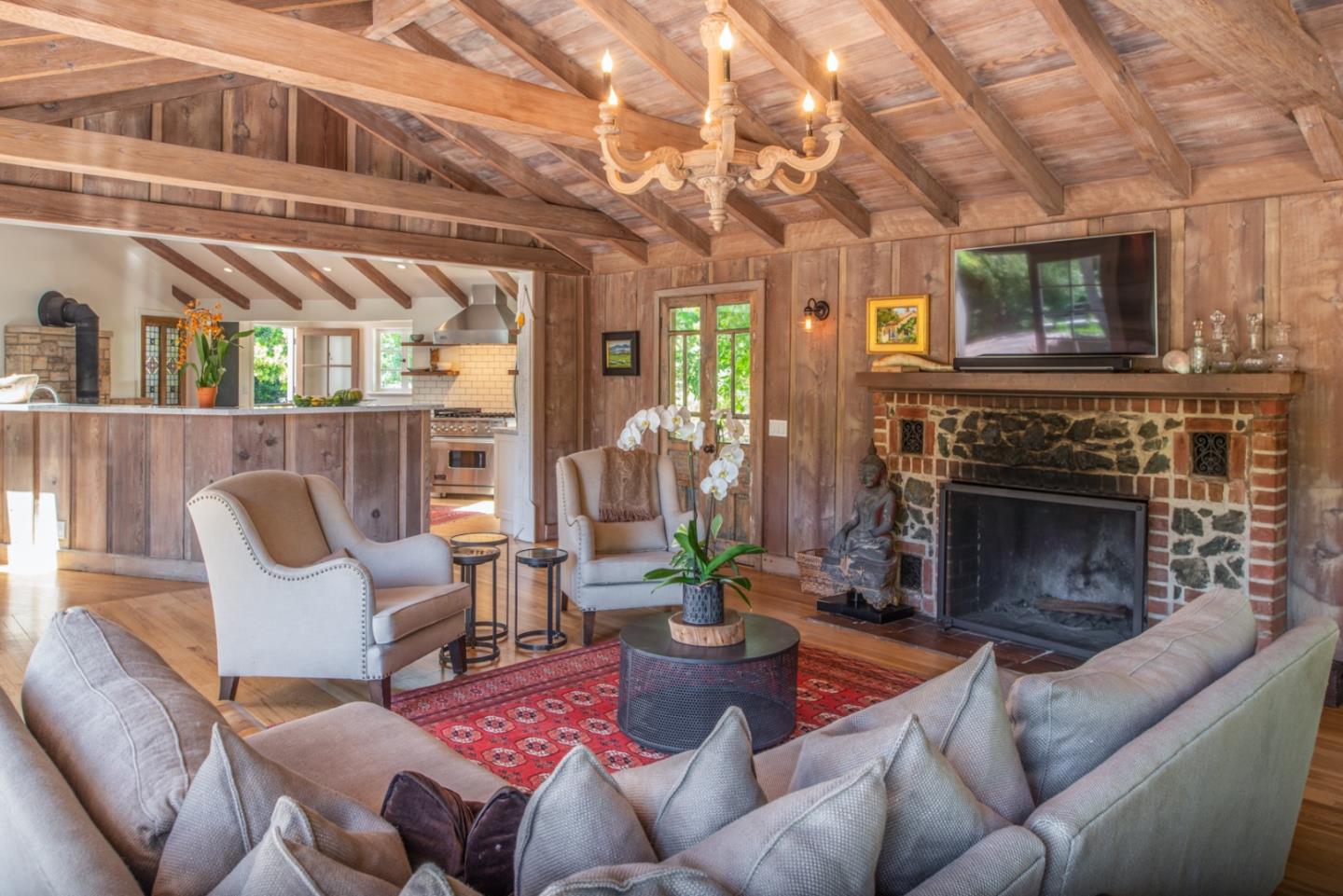 8990 West Carmel Valley Road Carmel Valley, CA 93923 - Photo 14 of 50 a living room with furniture and a fireplace