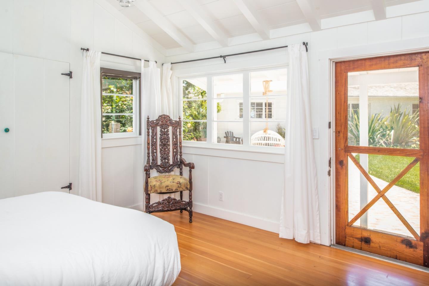 8990 West Carmel Valley Road Carmel Valley, CA 93923 - Photo 30 of 50 a bedroom with a bed and wooden floor