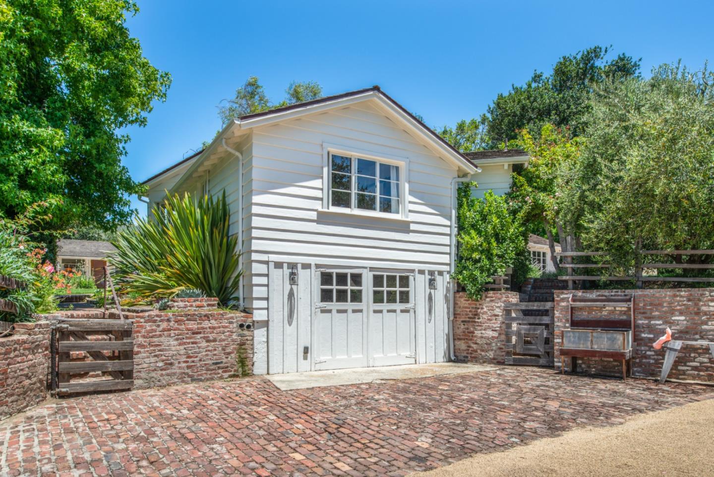 8990 West Carmel Valley Road Carmel Valley, CA 93923 - Photo 33 of 50 a front view of a house with garage