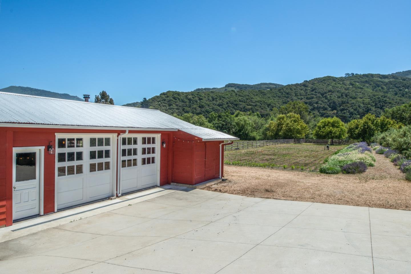 8990 West Carmel Valley Road Carmel Valley, CA 93923 - Photo 35 of 50 a view of a house with a yard and potted plants