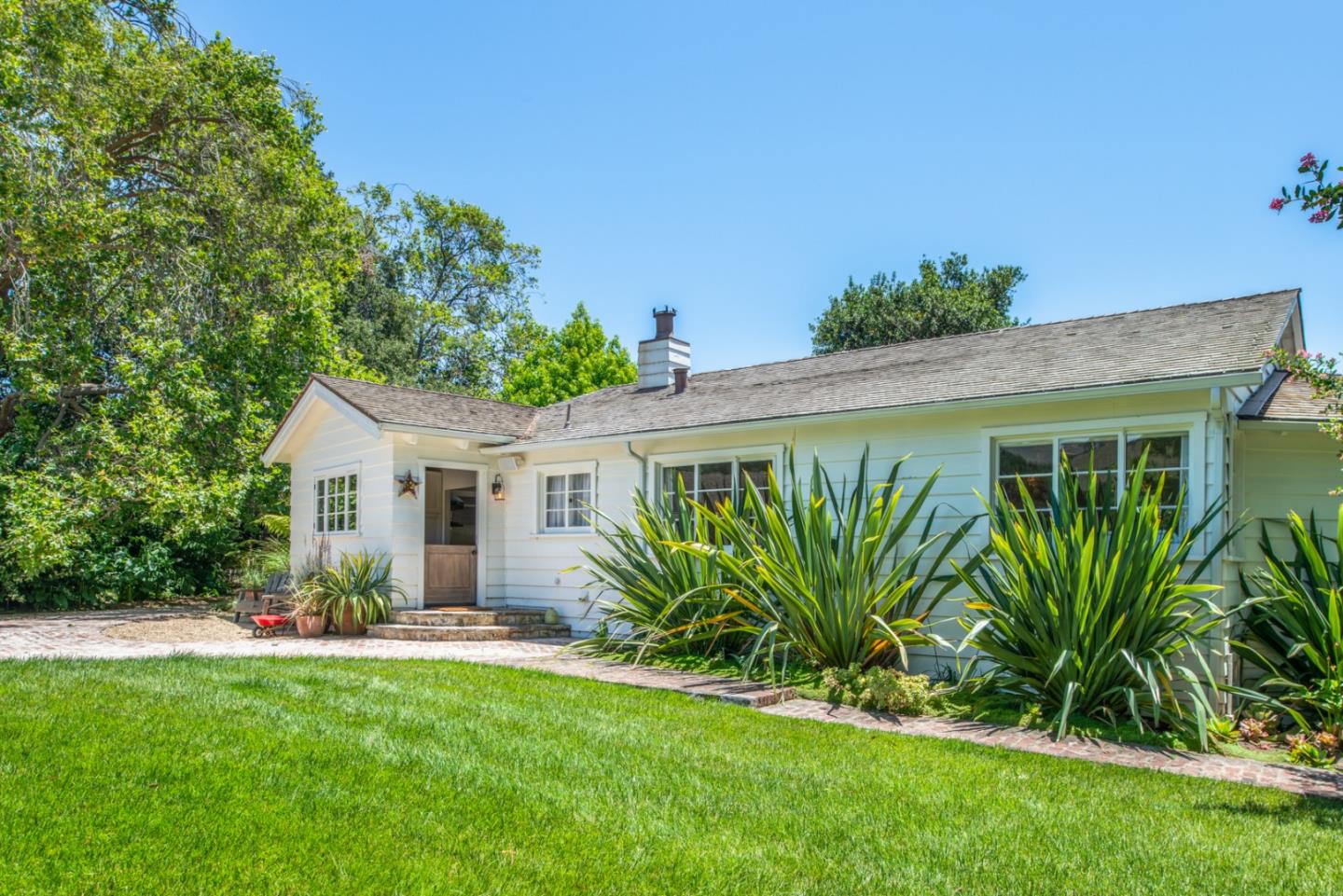 8990 West Carmel Valley Road Carmel Valley, CA 93923 - Photo 5 of 50 a view of a house with a yard and potted plants