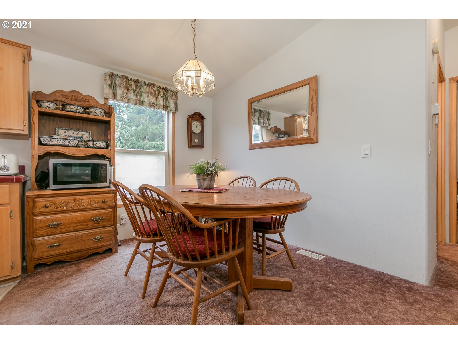 5703 Ridge Crest Drive Springfield, OR 97478 - Photo 14 of 23 a view of a dining room with furniture and chandelier