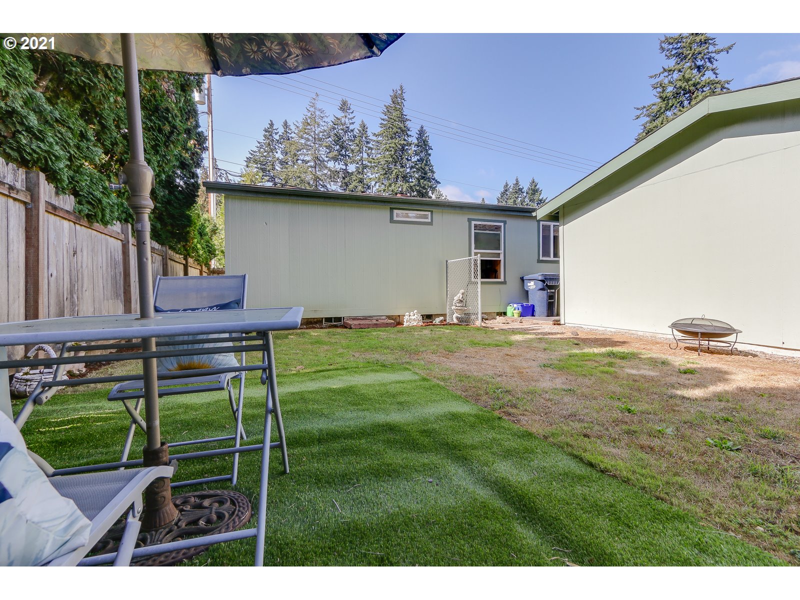 5703 Ridge Crest Drive Springfield, OR 97478 - Photo 22 of 23 a backyard of a house with table and chairs
