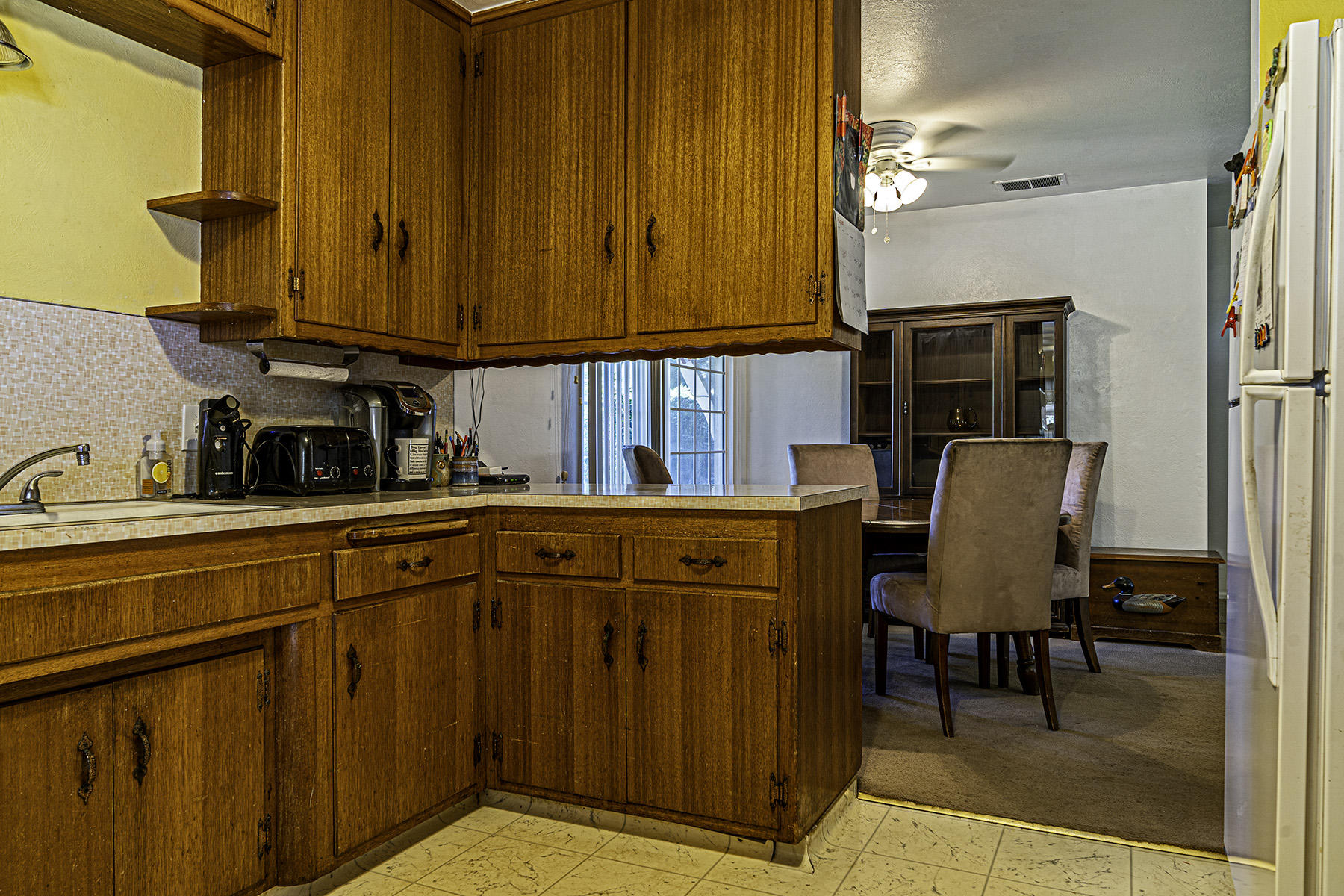 1205 Franzel Road Red Bluff, CA 96080 - Photo 10 of 28 a kitchen with stainless steel appliances granite countertop wooden cabinets a dining table and chairs