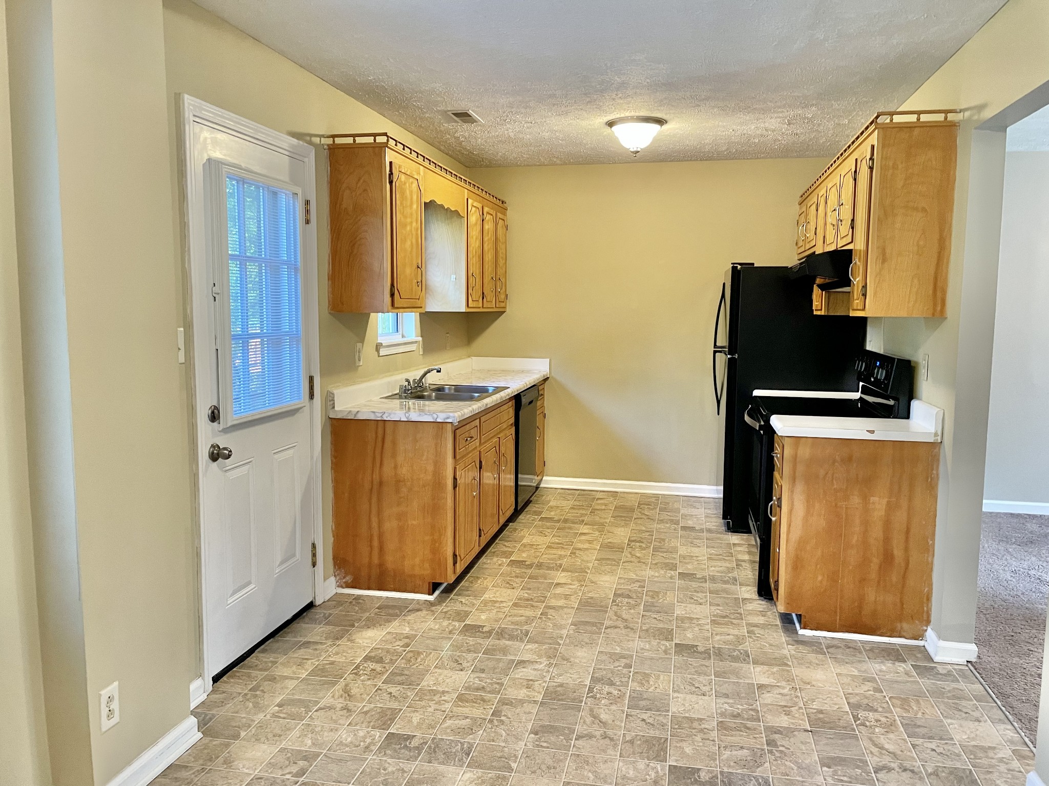 9193 Pembroke Oak Grove Road Oak Grove, KY 42262 - Photo 8 of 16 a kitchen with stainless steel appliances granite countertop a sink stove and refrigerator