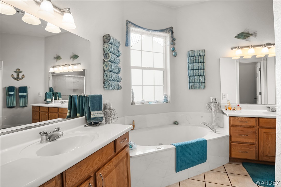 2898 Mountain Trail Road Kingman, AZ 86401 - Photo 16 of 75 a bathroom with a tub sink and mirror