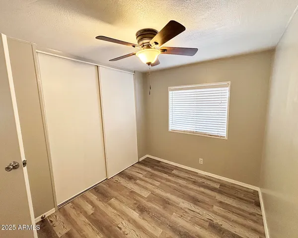 a view of room with window and ceiling fan