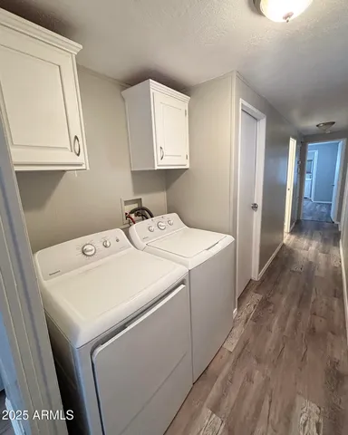 a kitchen with a refrigerator a stove top oven a washer and a dining table