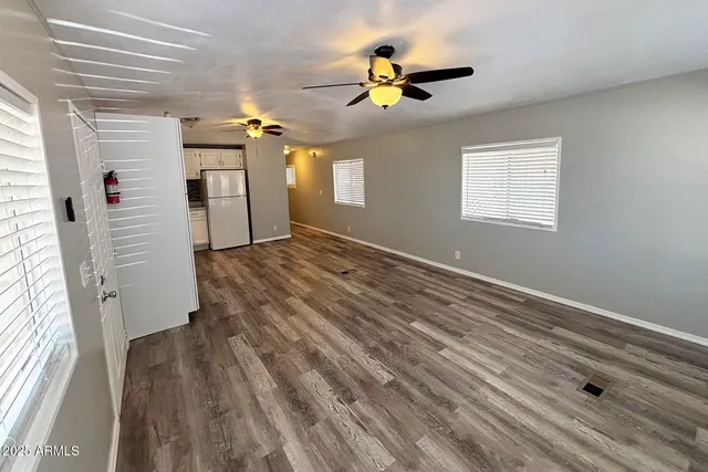 a kitchen with stainless steel appliances a white cabinets and wooden floor