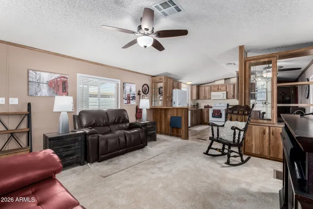 a kitchen with stainless steel appliances granite countertop a stove a refrigerator a dining table and chairs with wooden floor