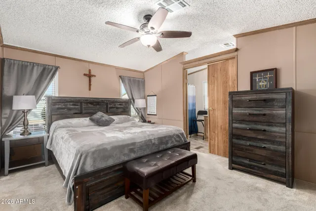 a bedroom with a bed and a chandelier