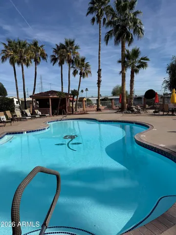 a view of a swimming pool with a table and chairs