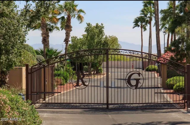 a view of a patio with chairs and table under an umbrella