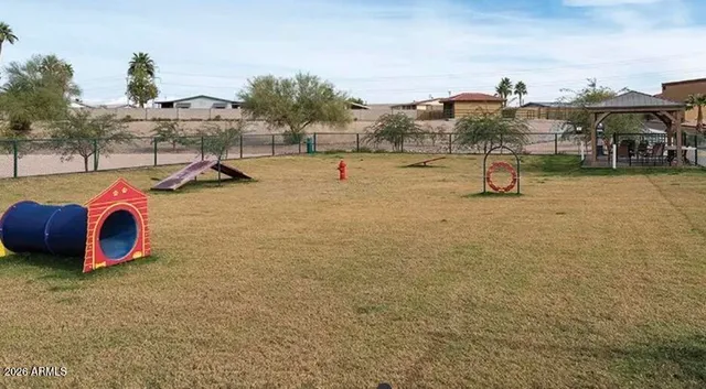 a room with pool table wooden floor and windows
