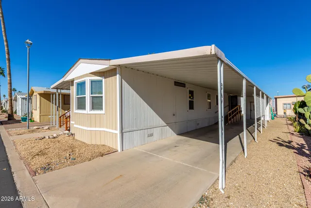 a view of a house with wooden fence