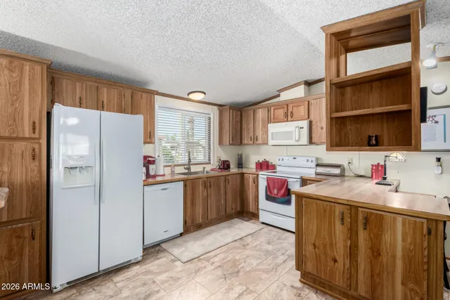 a kitchen with a stove top oven sink and cabinets